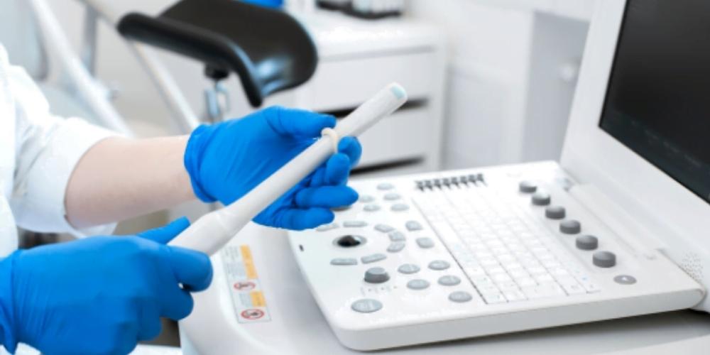 Practitioner applies ultrasound probe cover to transducer for endocavity procedure