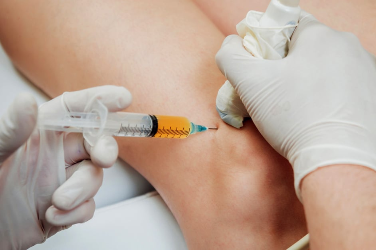 Ultrasound-guided regenerative medicine knee injection performed by a sports medicine physician.